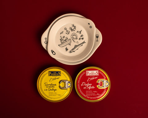 Two circular tins, one yellow and one red, beneath two illustrated plates.